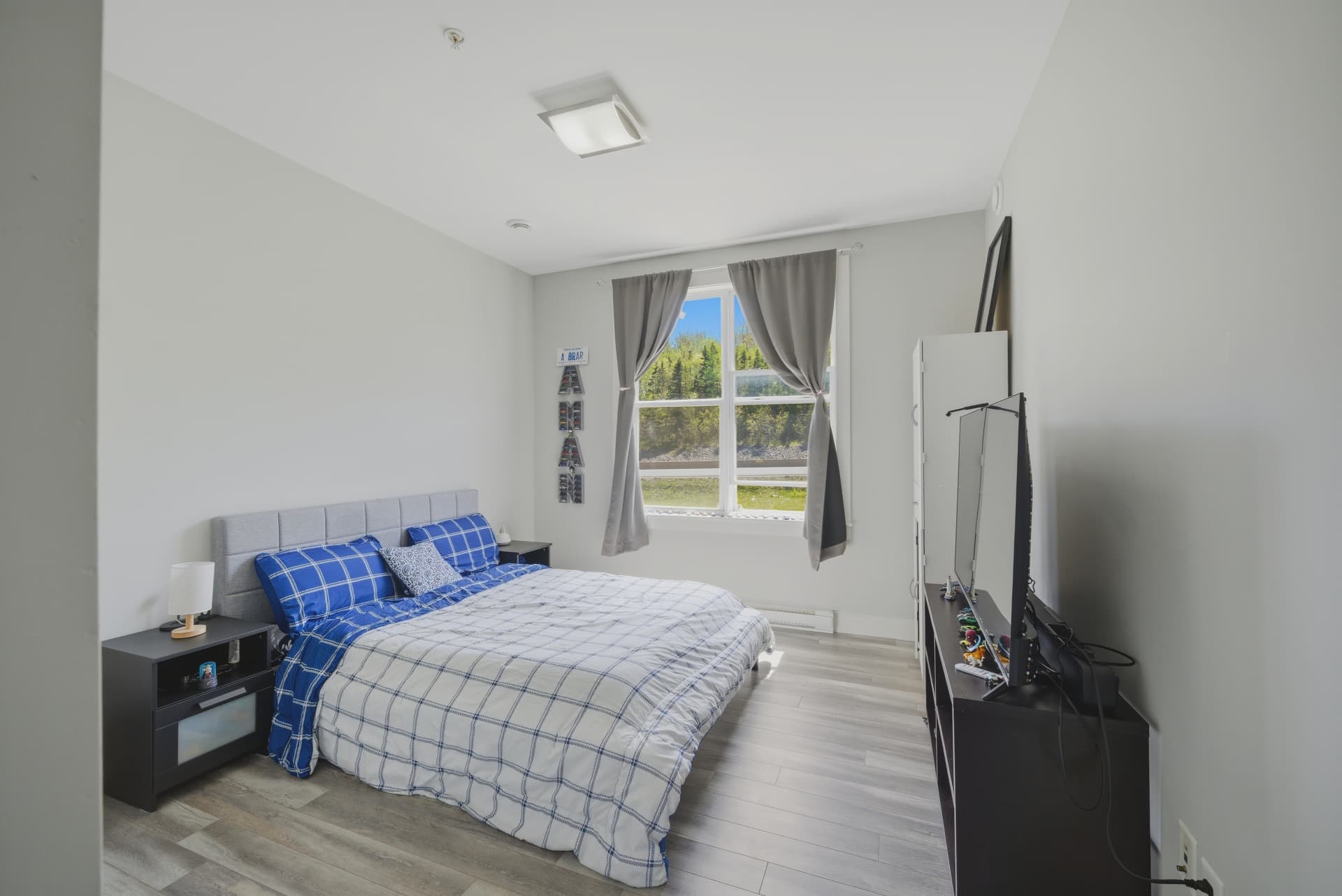 Sunlit bedroom with forest view